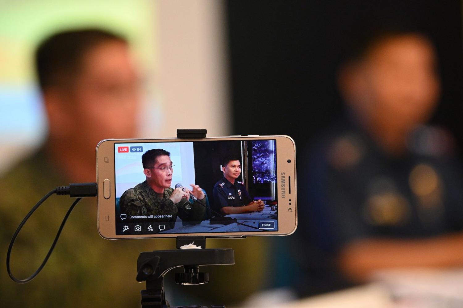 Philippine security personnel brief the media on investigations following a June bombing (Photo: Ted Aljibe via Getty)