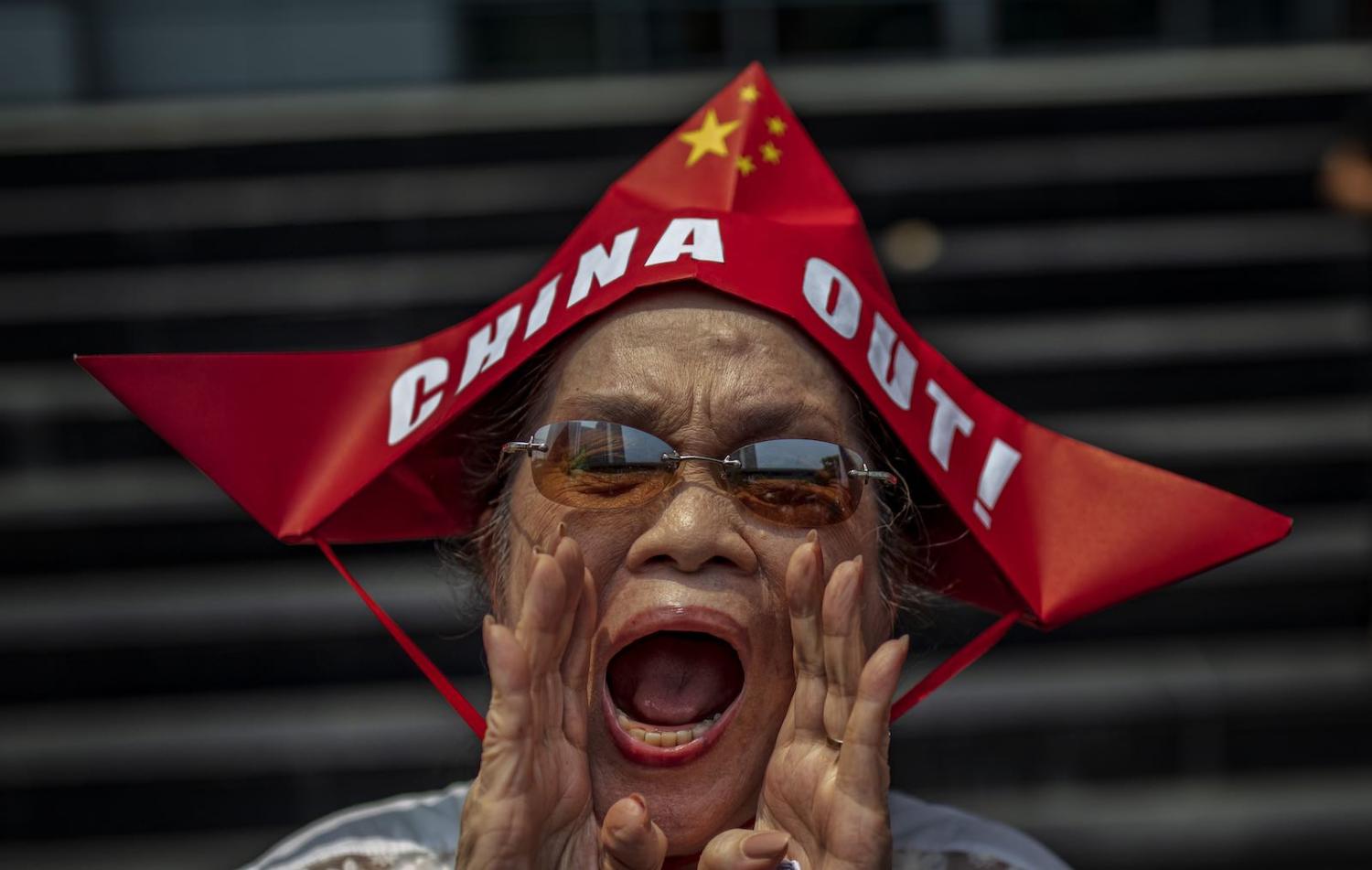 A woman shouts during a protest outside the Chinese Embassy in Manila, Philippines, 12 July 2019 (Photo: Ezra Acayan/Getty Images)