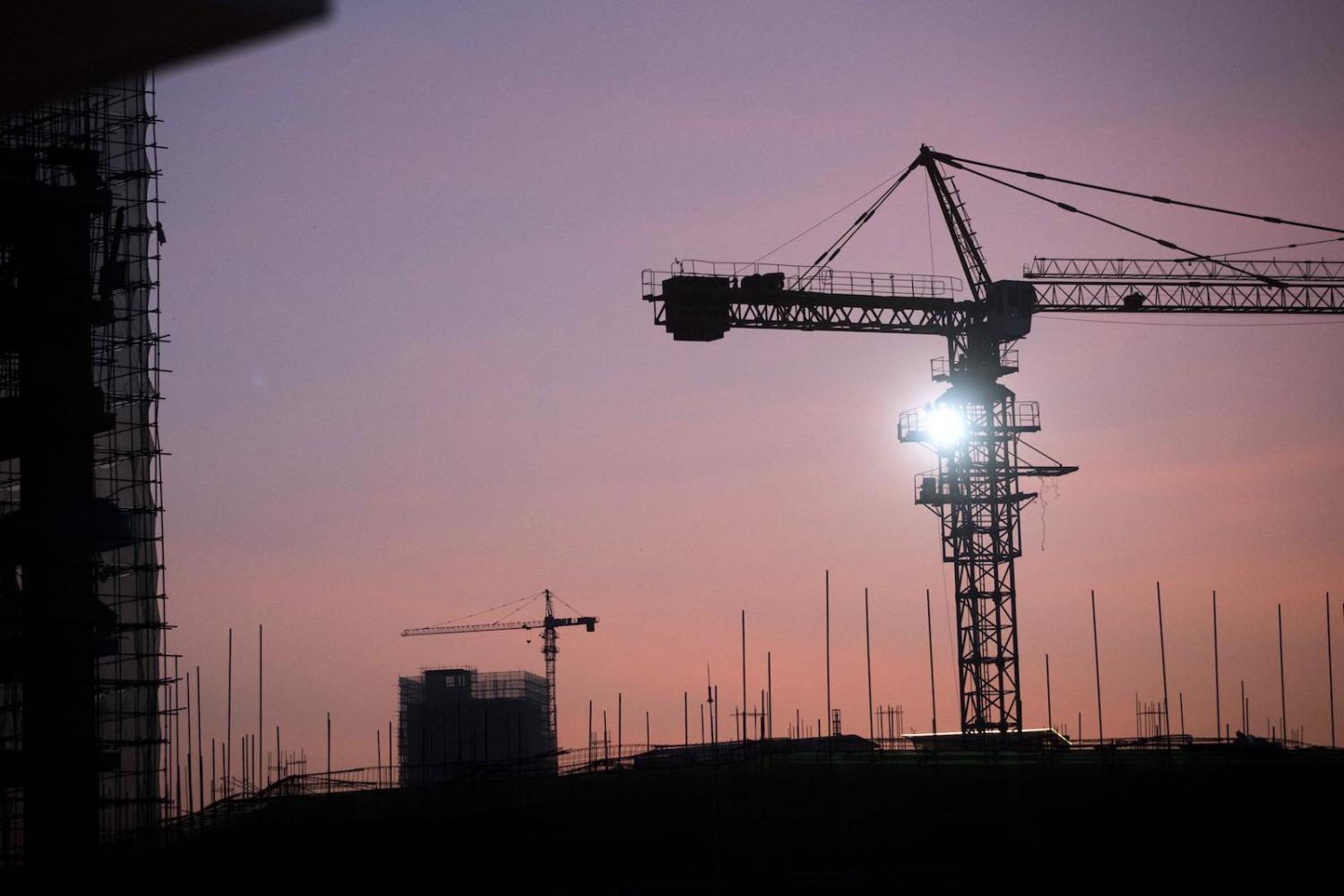 Cranes stand on a construction site at dawn in Sihanoukville, Cambodia, part of an infusion of Chinese-built infrastructure (Photo: Brent Lewin via Getty)