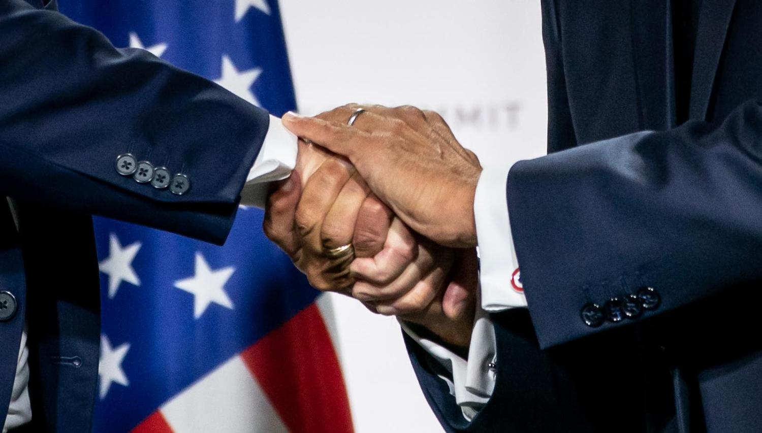 US President Trump and French President Emmanuel Macron shake hands at the final press conference of the G7 Summit, Biarritz, France, 26 August 2019 (Photo: Michael Kappeler via Getty)