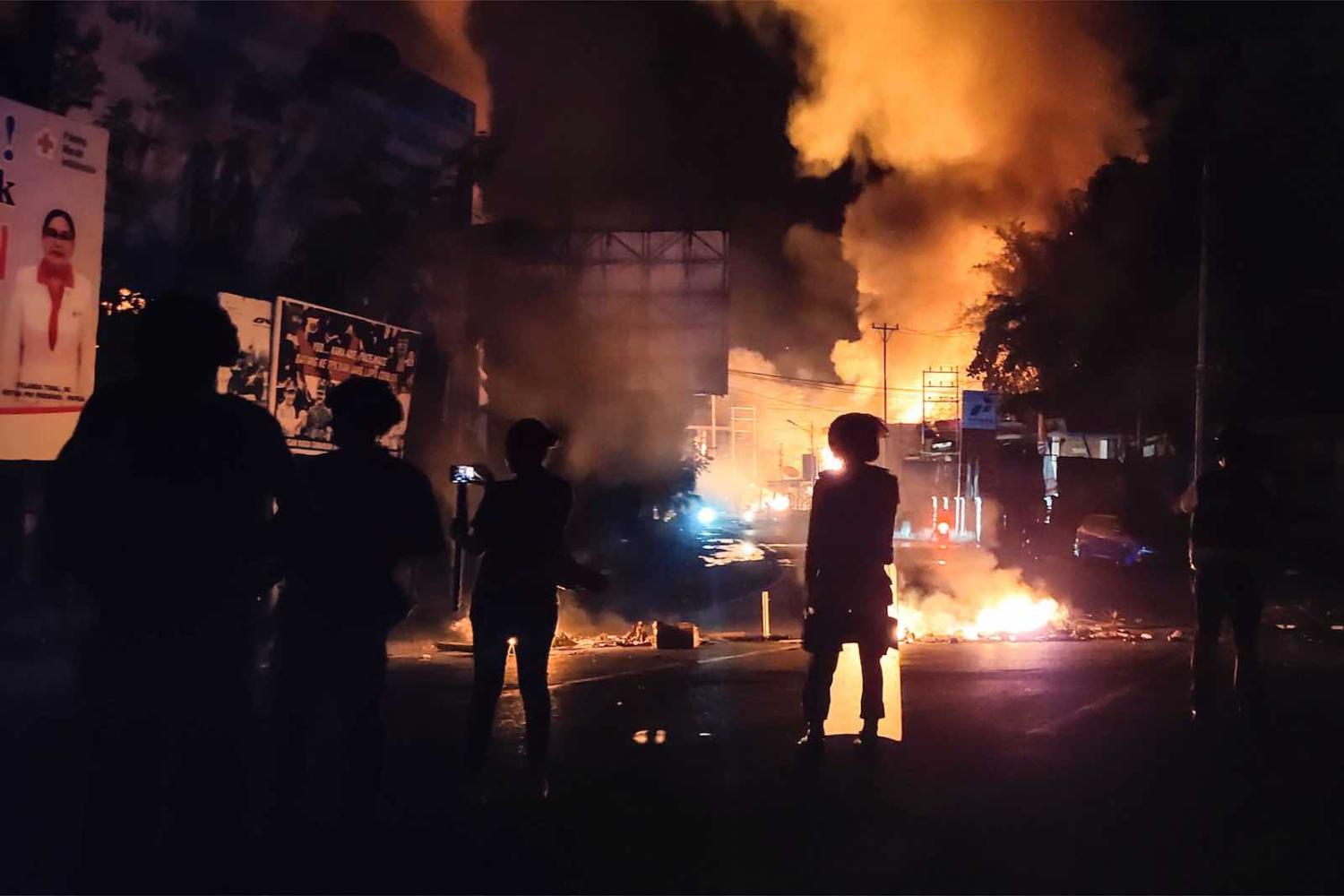 Buildings burn after hundreds of demonstrators marched near Papua’s biggest city, Jayapura, on 29 August (Photo: Indra Thamrin Hatta/AFP/Getty Images)