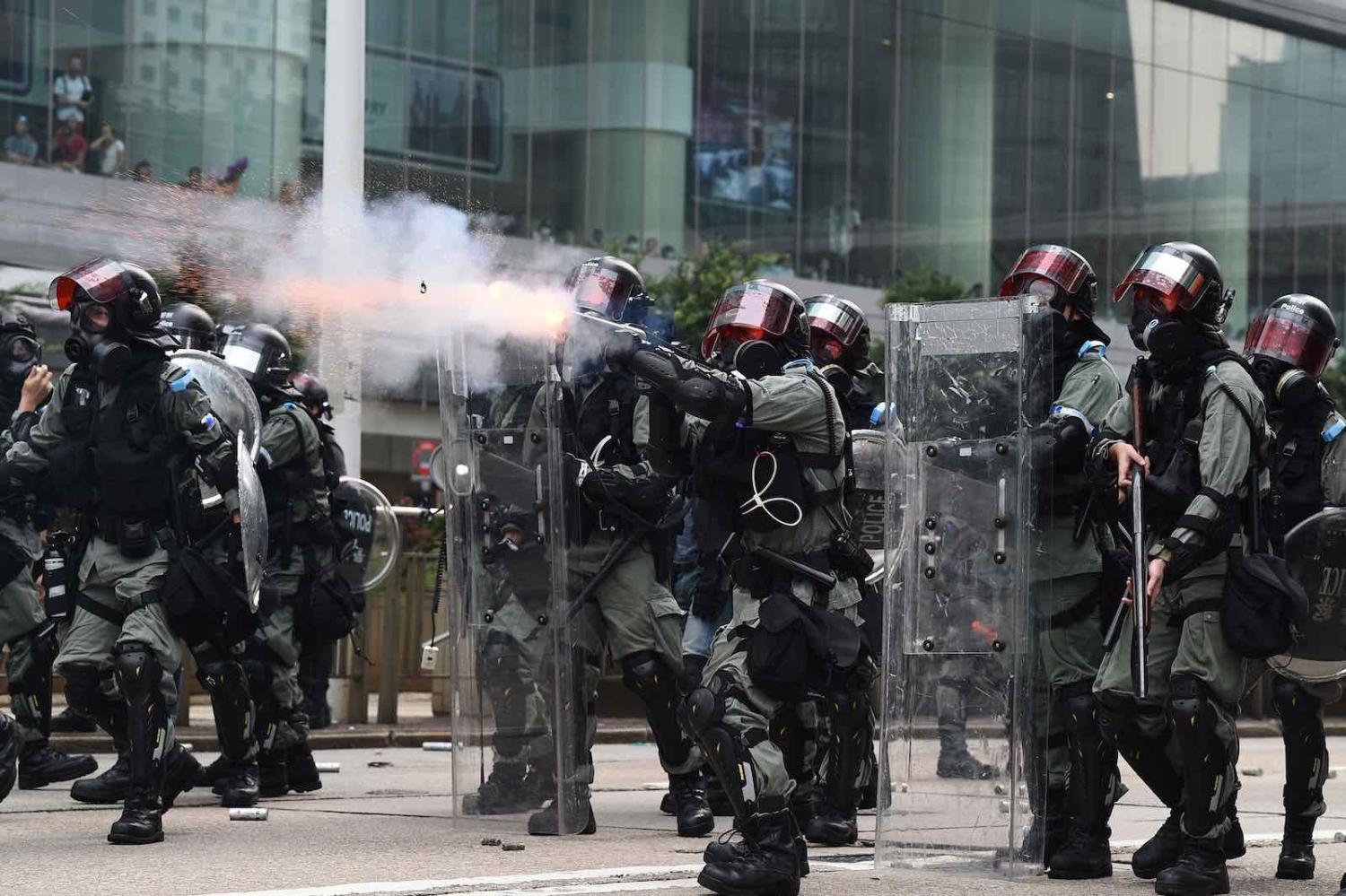 Hong Kong police fire tear gas towards marching protesters, 29 September 2019, a day of global protests ahead of communist China’s 70th birthday (Photo by Mohd Rasfan/AFP/Getty Images)