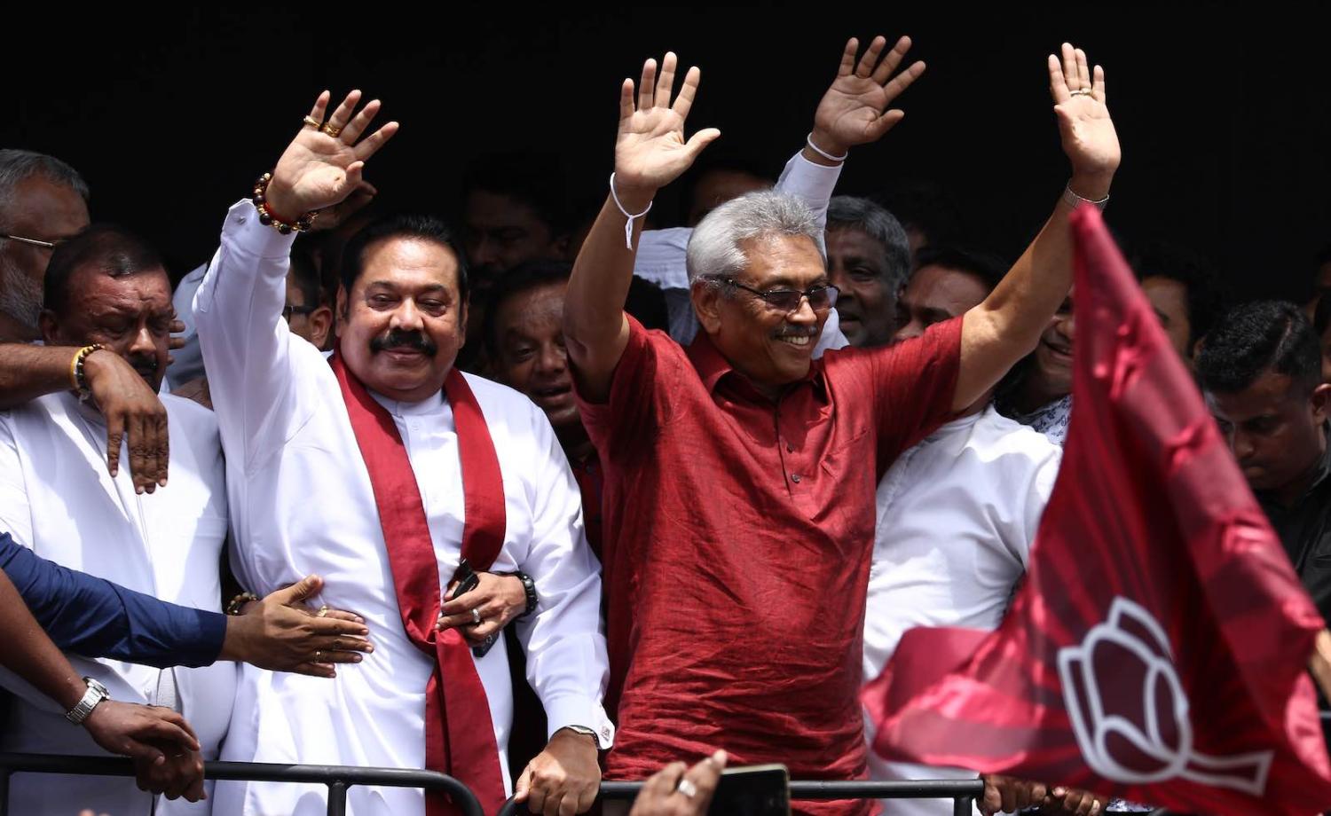 Sri Lankan presidential candidate Gotabaya Rajapaksa (R) and his brother, former president Mahinda Rajapaksa (L), greet supporters in Colombo, 7 October 2019. (Photo by Tharaka Basnayaka/NurPhoto via Getty)