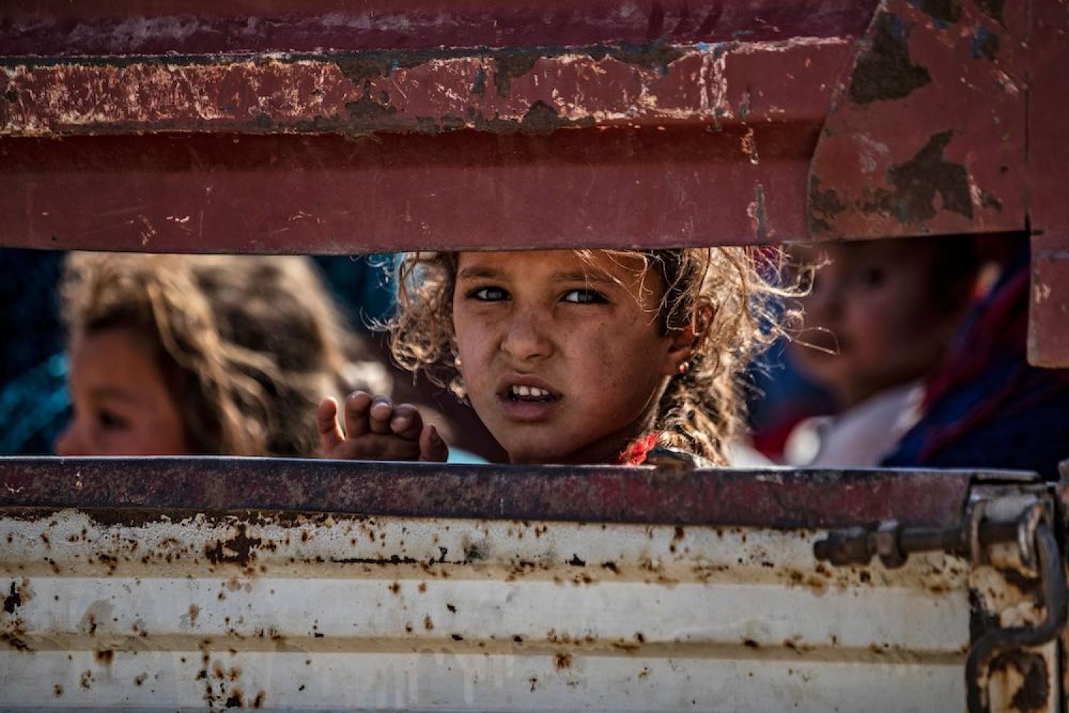 Syrian Arab and Kurdish civilians arrive at Tall Tamr town, in Syria’s Hasakeh province, after fleeing Turkish bombardment along the border, 10 October 2019 (Photo: Delil Souleiman/AFP/Getty Images)