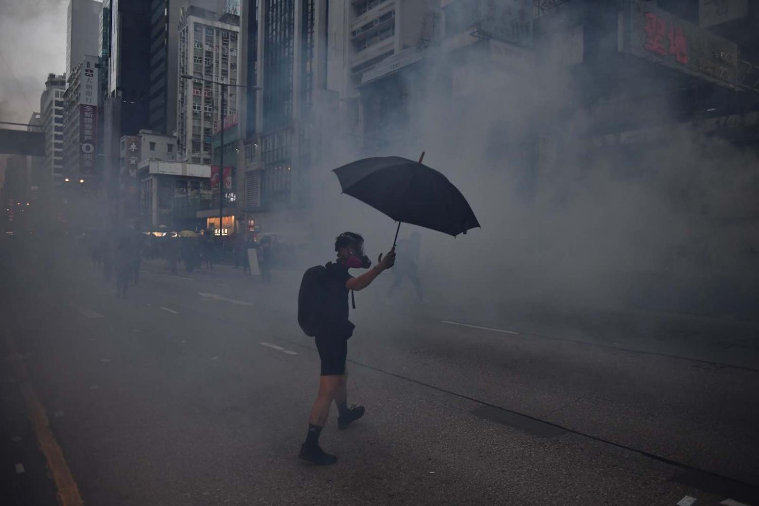The near ubiquitous smoke-halo for images of protesters (Photo: Ed Jones/AFP/Getty Images)