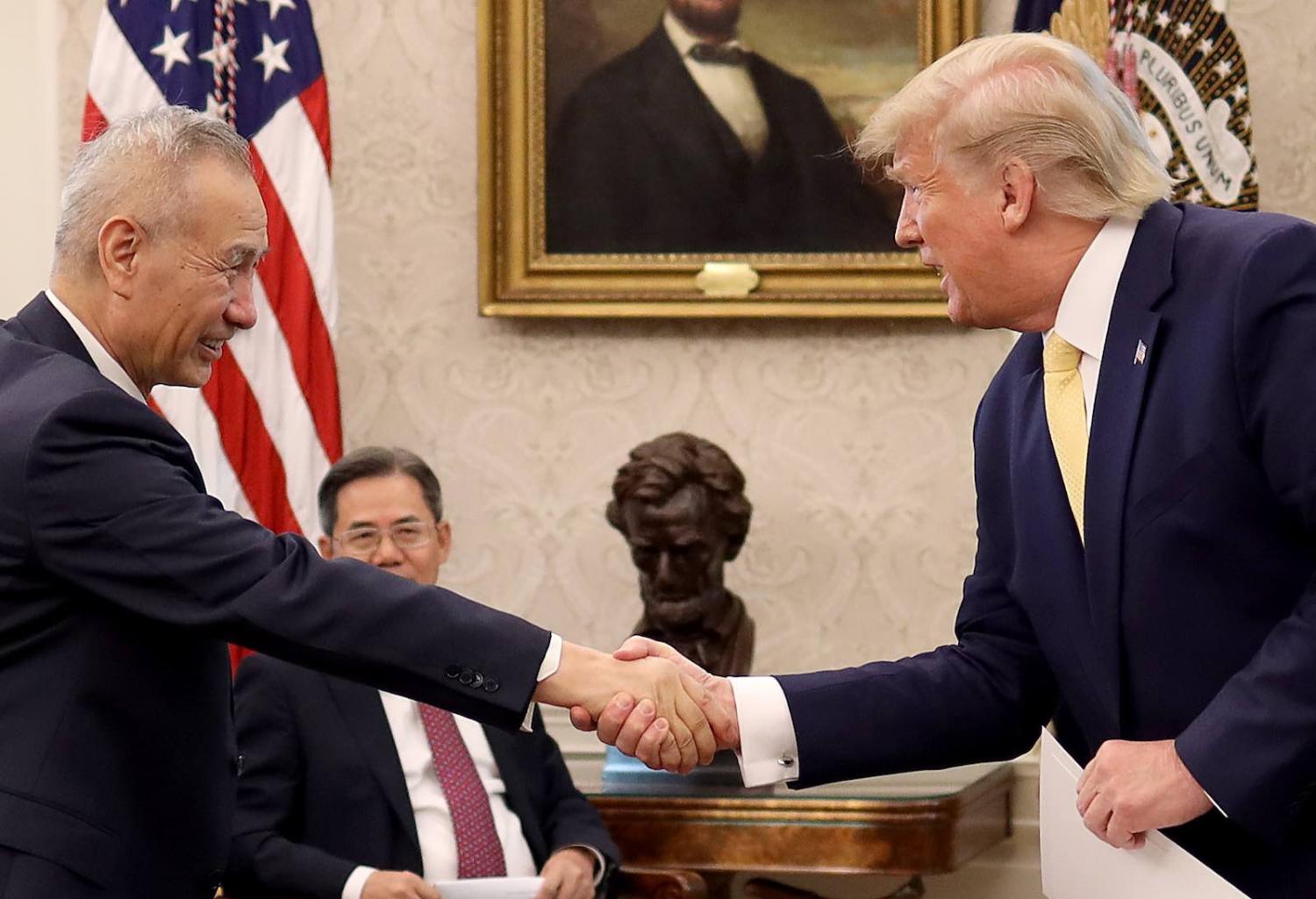 President Donald Trump shakes hands with Chinese Vice Premier Liu He after announcing a “phase one” trade agreement with China in the Oval Office on Friday (Photo: Win McNamee/Getty Images)