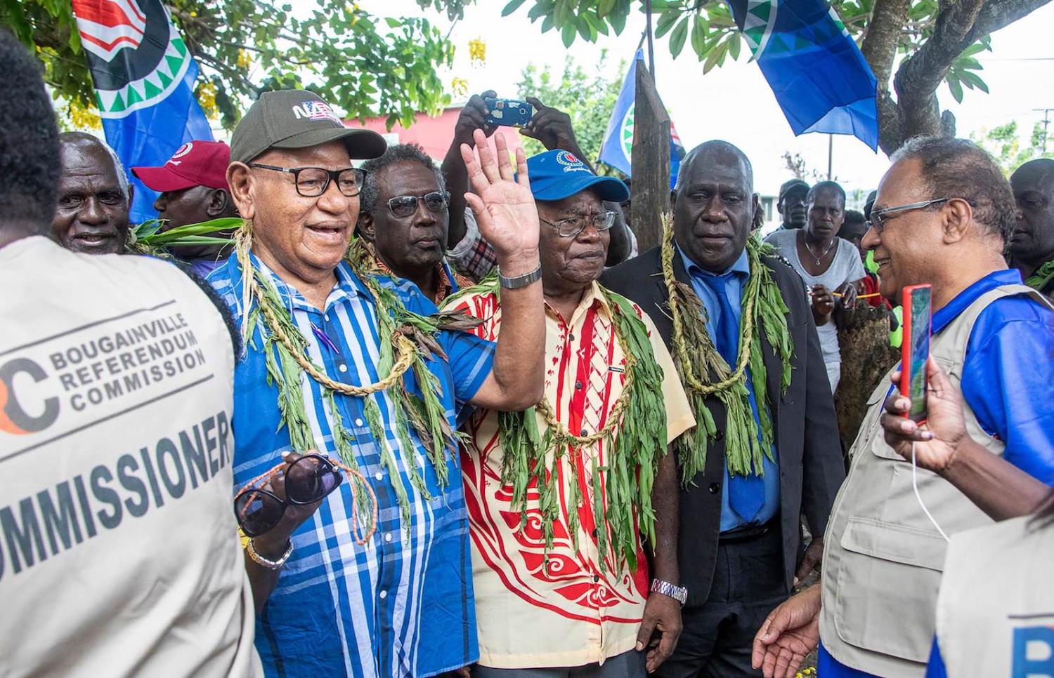 John Momis waves for the camera when about to cast a ballot in Bougainville’s independence vote in Buka on 23 November 2019 (Ness Kerton/AFP/Getty Images)