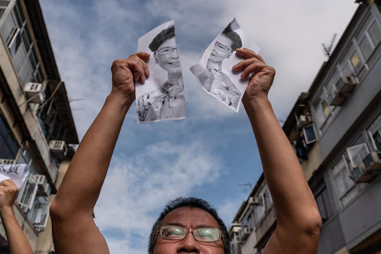 A protester holds a torn portrait of Hong Kong Chief Executive Carrie Lam during a rally in Sheung Shui district Hong Kong on 5 January 2020 (Photo: Anthony Kwan/Getty Images)