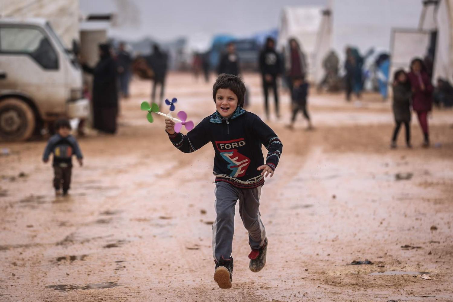 A boy plays at a makeshift camp for people displaced by conflict, Idlib, Syria, 6 February (Photo: Anas Alkharboutli/picture alliance via Getty Images)
