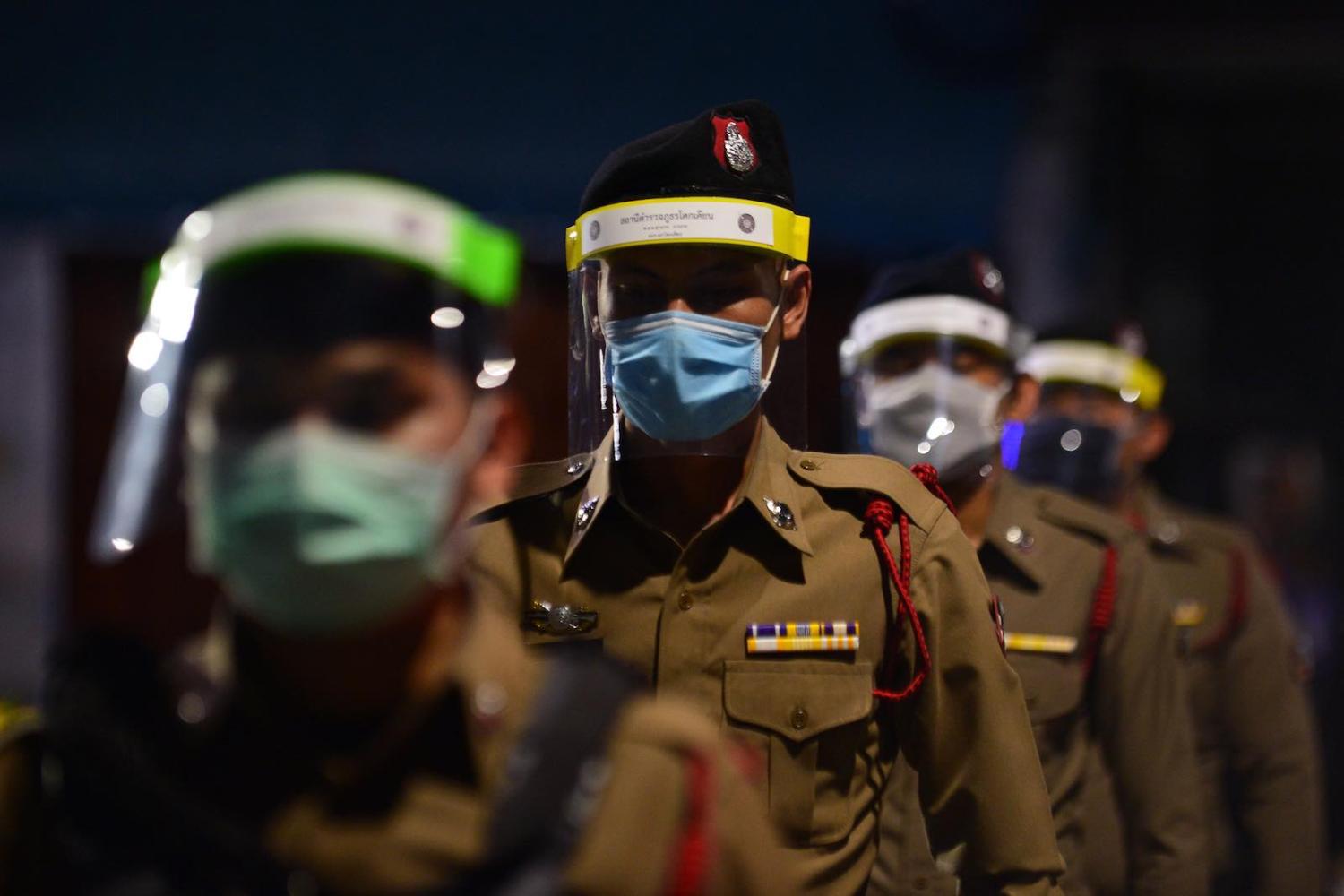 Police enforcing a nationwide night curfew in Thailand’s southern province of Narathiwat aimed at stemming the spread of coronavirus (Madaree Tohlala/AFP/Getty Images)