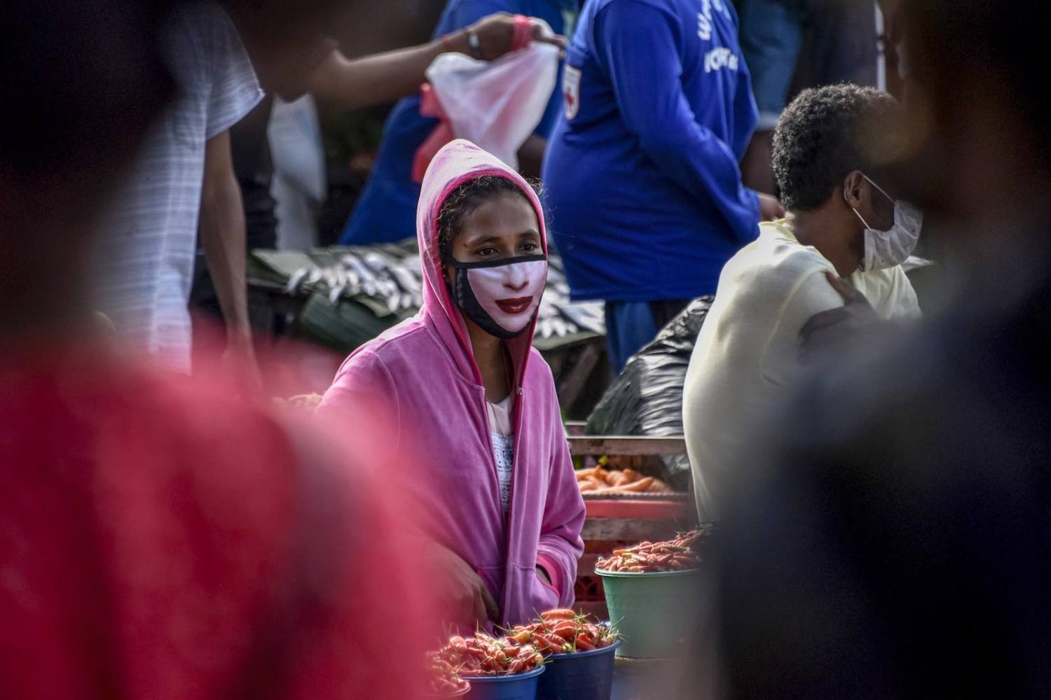 A woman selling vegetables at a market in Dili, 16 April (Valentino Dariell de Sousa/AFP via Getty)