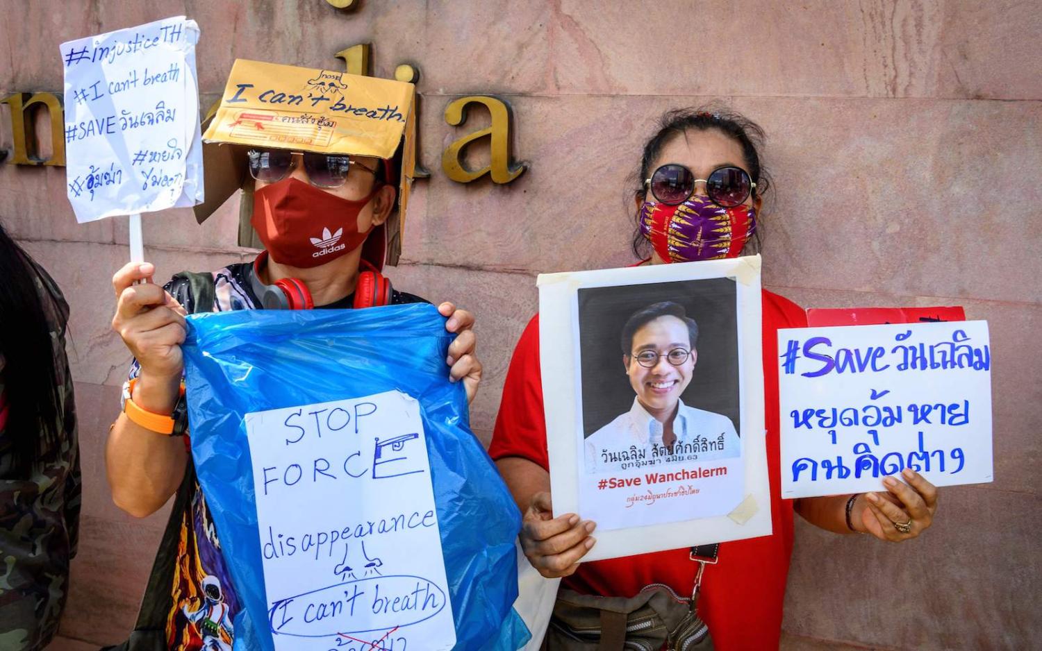 Protesters hold signs of Thai activist Wanchalearm Satsaksit outside the Cambodian embassy in Bangkok, 8 June 2020 (Mladen Antonov/AFP via Getty Images)