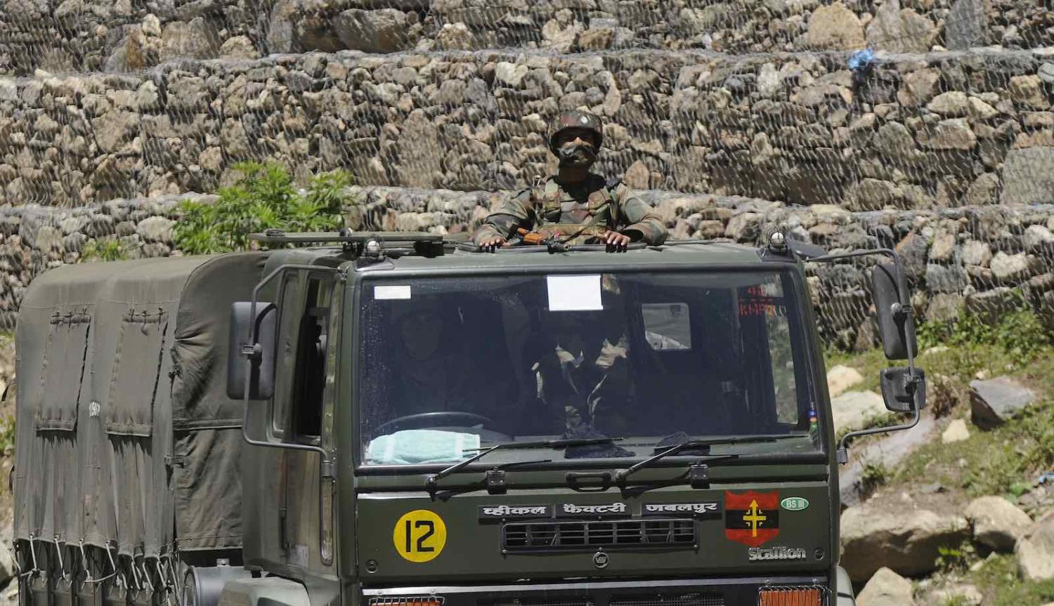 An Indian Army soldier looks out from a truck in a convoy to Ladakh, 22 June  2020 in Ganderbal, India (Waseem Andrabi/Hindustan Times via Getty Images)