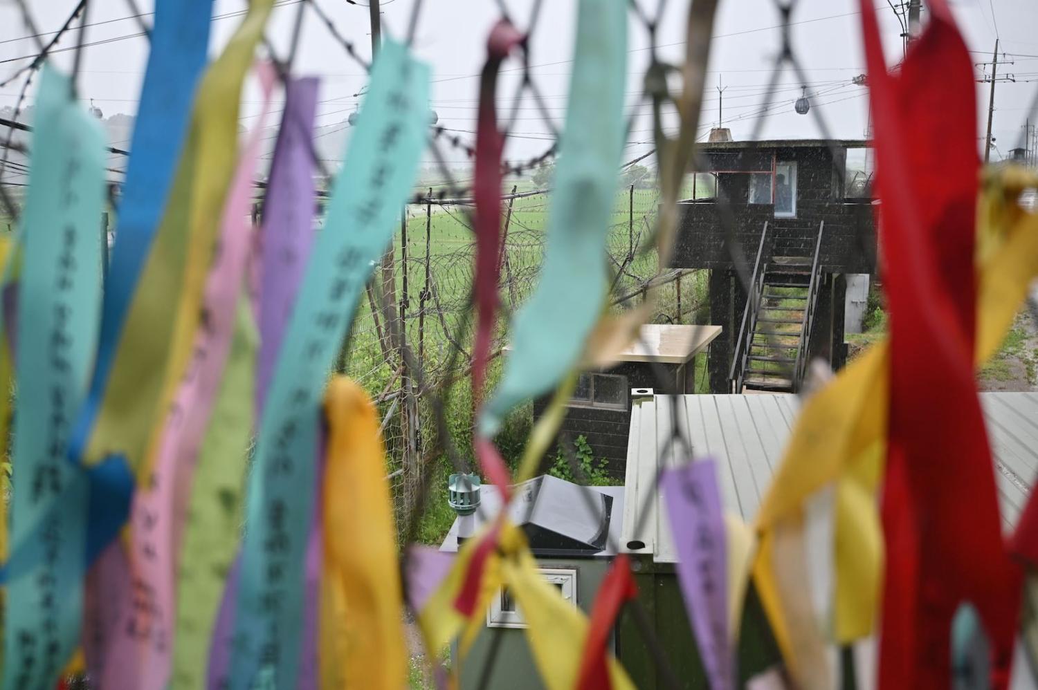 A South Korean guard post seen through a fence decorated with ribbons with messages of peace and reunification, at Imjingak peace park in the border city of Paju, June 2020 (Jung Yeon-je/AFP via Getty Images)