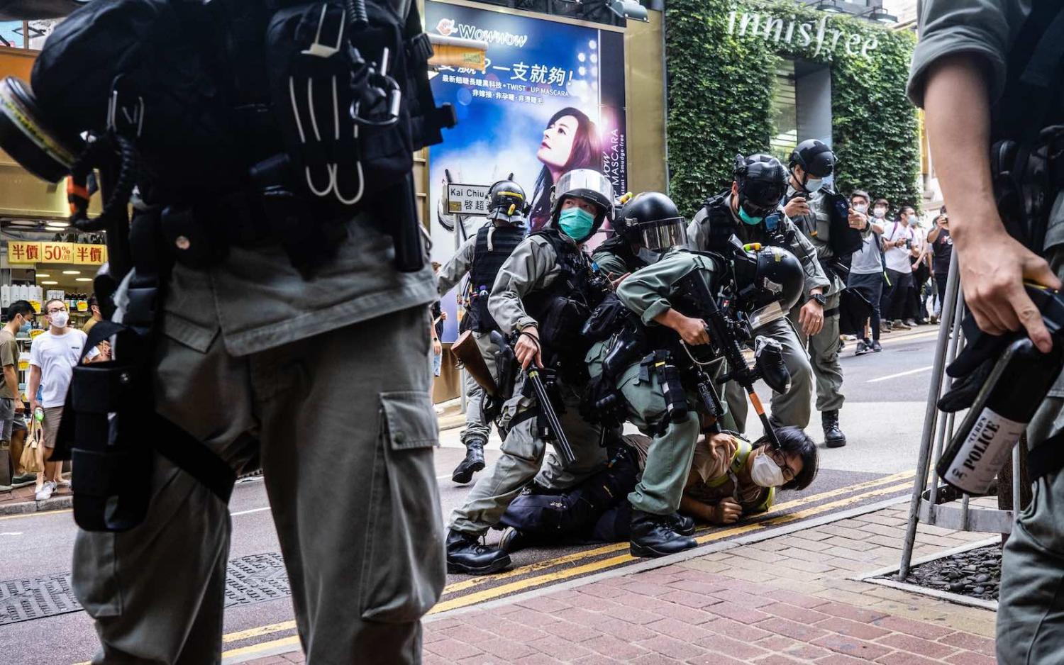 Riot police pin down a protester during a demonstration after the passage of a new security law in Hong Kong, 1 July 2020 (Willie Siau/SOPA Images/LightRocket via Getty Images)