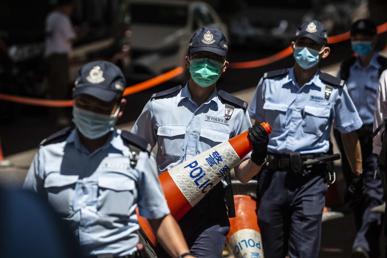 Police set up a cordon outside West Kowloon court in Hong Kong on 6 July (Isaac Lawrence/AFP via Getty Images)