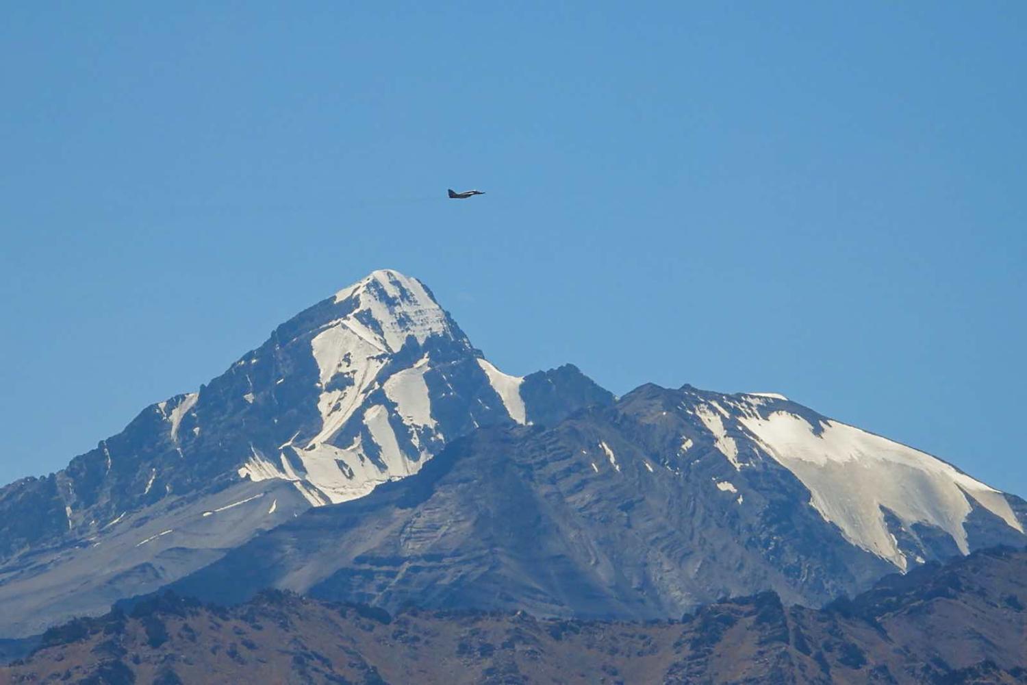 An Indian fighter jet on 2 September flying over a mountain range in Ladakh (Mohd Arhaan Archer/AFP via Getty Images)
