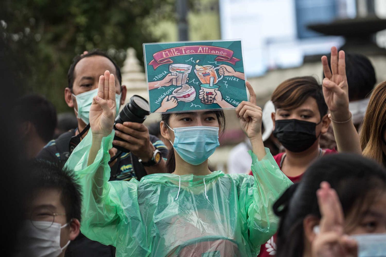 A protester in Bangkok in October, the sign featuring causes spanning Thailand, Taiwan, Hong Kong and India (Geem Drake via Getty Images)