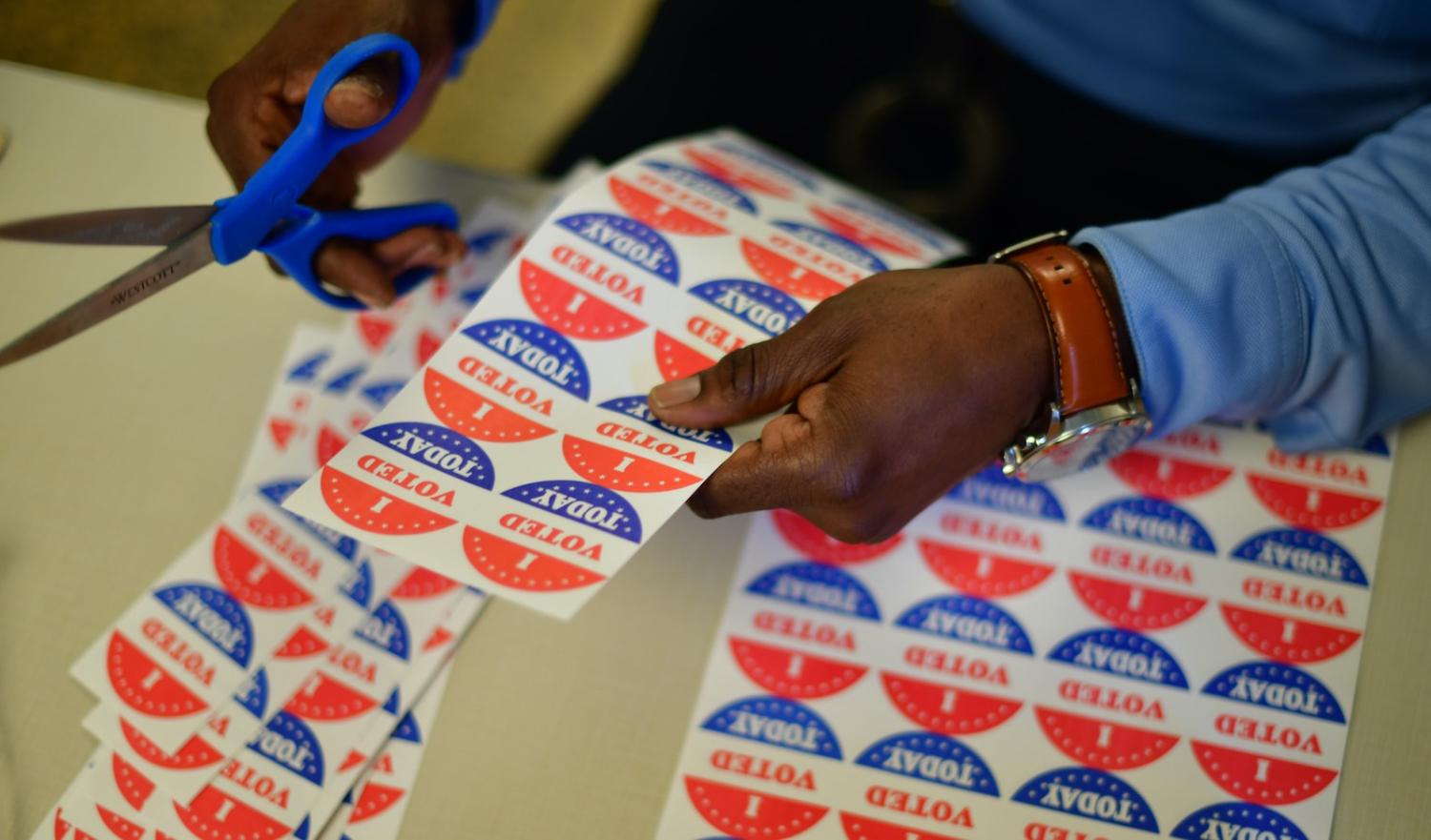 A volunteer cuts out stickers for voters at a polling station in Philadelphia, Pennsylvania, a key state in this year’s election (Mark Makela/Getty Images)