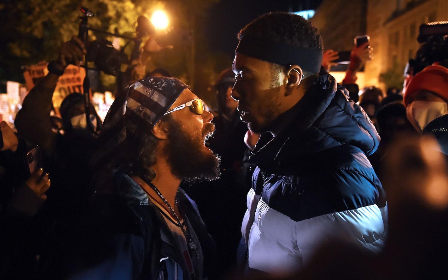 A Trump supporter (left) clashes with a demonstrator at Black Lives Matter plaza, across from the White House in Washington, DC, on 3 November 2020 (Olivier Douliery/AFP via Getty Images)