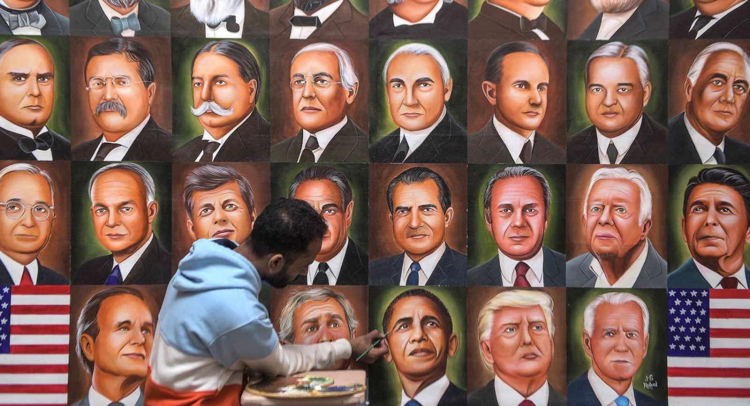 A painter puts the finishing touches on a mural of US presidents in Amritsar, India, 8 November 2020 (Narinder Nanu/AFP via Getty Images)