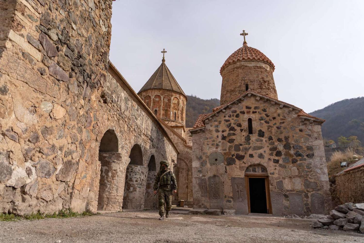 A Russian peacekeeper walks past the 12th–13th century Orthodox Dadivank Monastery, outside the town of Kalbajar on 16 November (Andrey Borodulin/AFP via Getty Images)