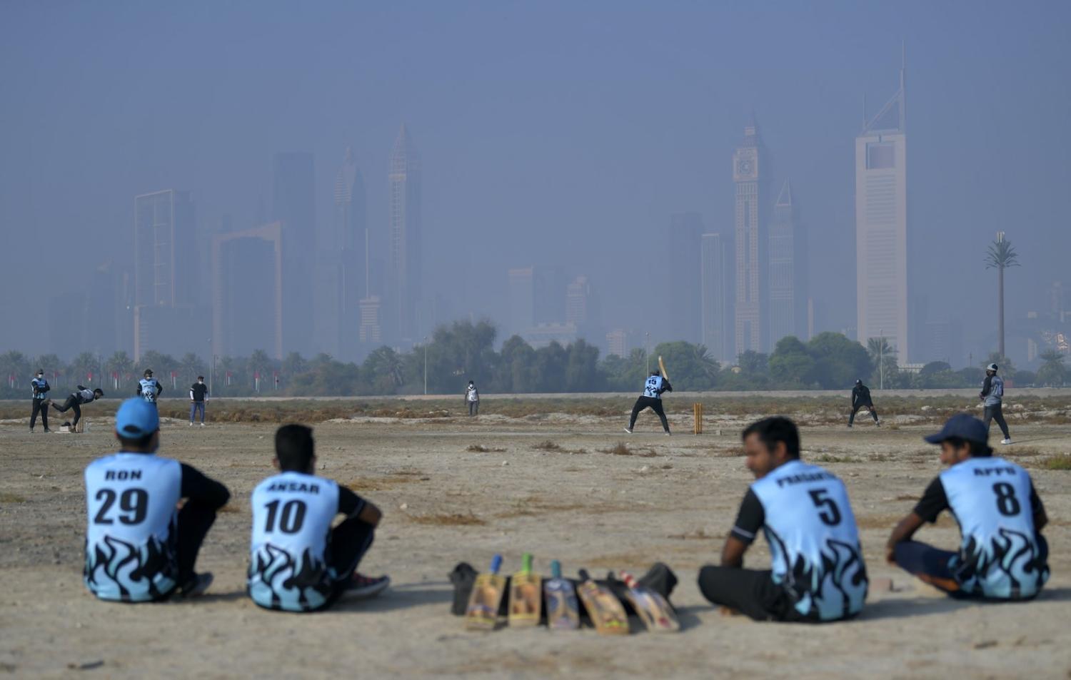 Workers in Dubai play cricket on their day off, 4 December 2020 (Karim SAHIB/AFP via Getty Images)