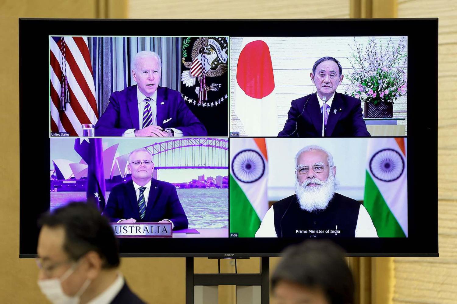 A monitor displays the leaders of the US, Japan, India and Australia during a virtual Quadrilateral Security Dialogue meeting, 12 March in Tokyo (Kiyoshi Ota/Pool/AFP via Getty Images)