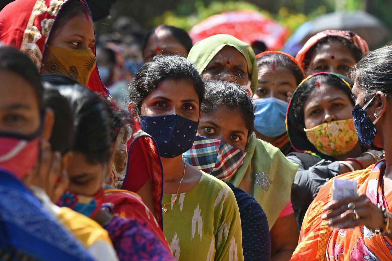 Women wait to cast their ballots during the fifth phase of West Bengal’s state legislative assembly elections, 17 April 2021 in Kolkata (Dibyangshu Sarkar/AFP via Getty Images)