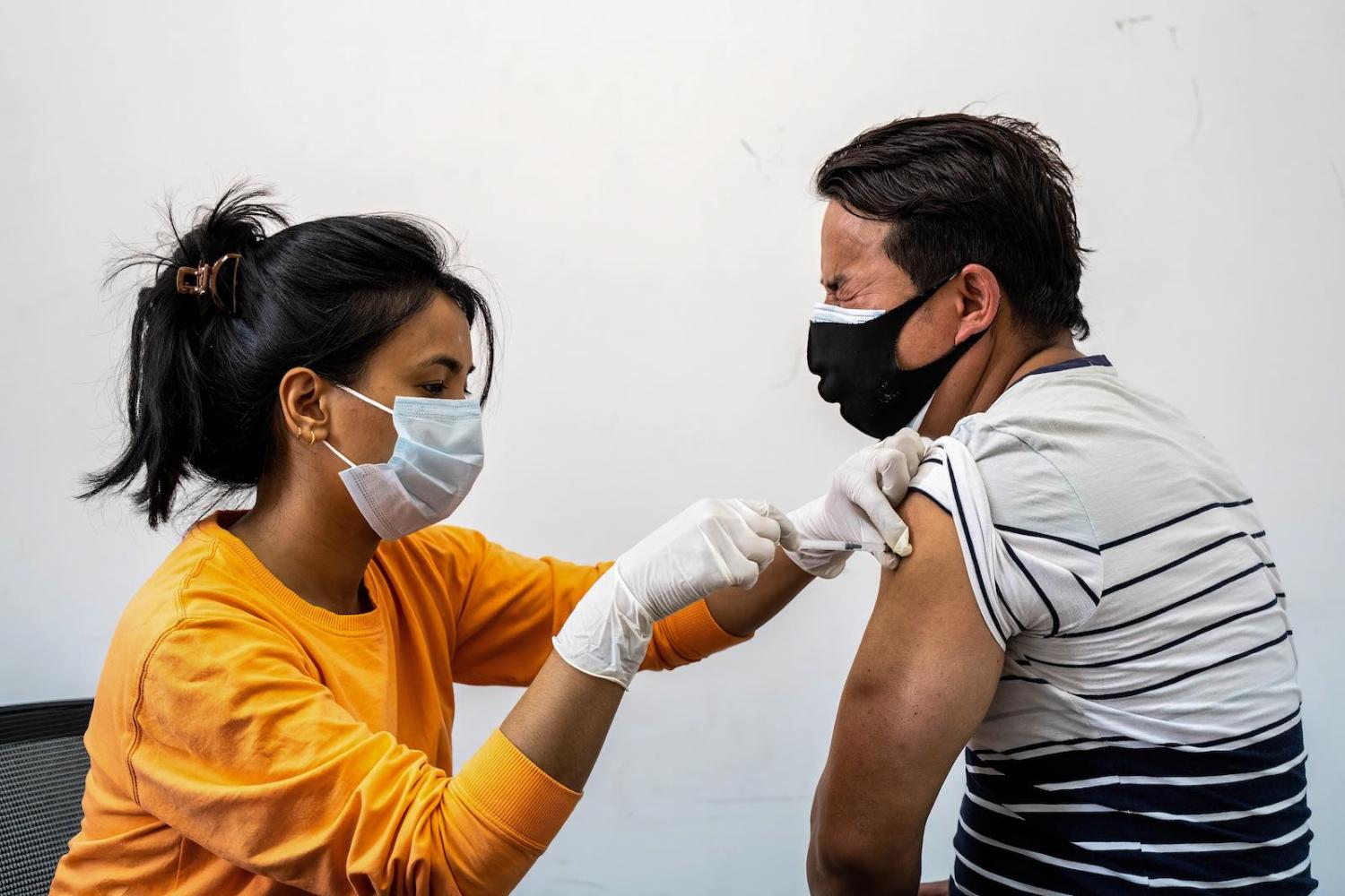 A Nepali man taking his first jab of Sinopharm vaccine at a health facility in Kathmandu, 26 April (Dipendra Rokka/SOPA Images/LightRocket via Getty Images)