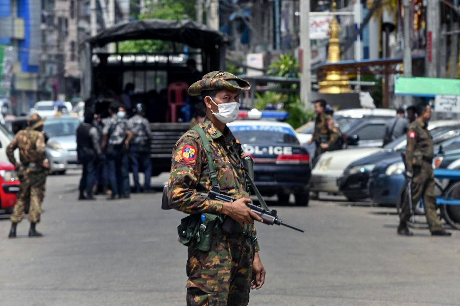 A soldier stands guard as security forces search for protesters who had been taking part in a demonstration in Yangon, 7 May 2021 (STR/AFP via Getty Images)