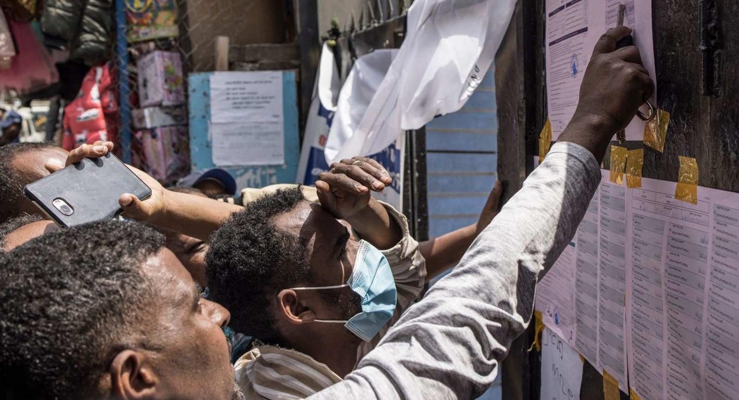 Voters check tallies at a polling station in Addis Ababa, 22 June 2021 (Marco Longari/AFP via Getty Images)