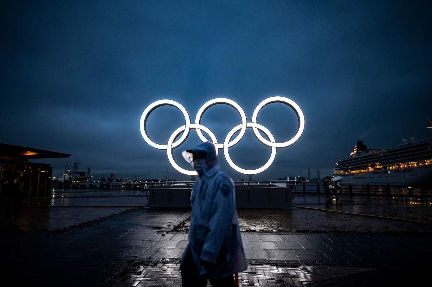 Olympic rings for the delayed Tokyo 2020 Summer Games light up at dusk in Yokohama, 2 July 2021 (Philip Fong/AFP via Getty Images)