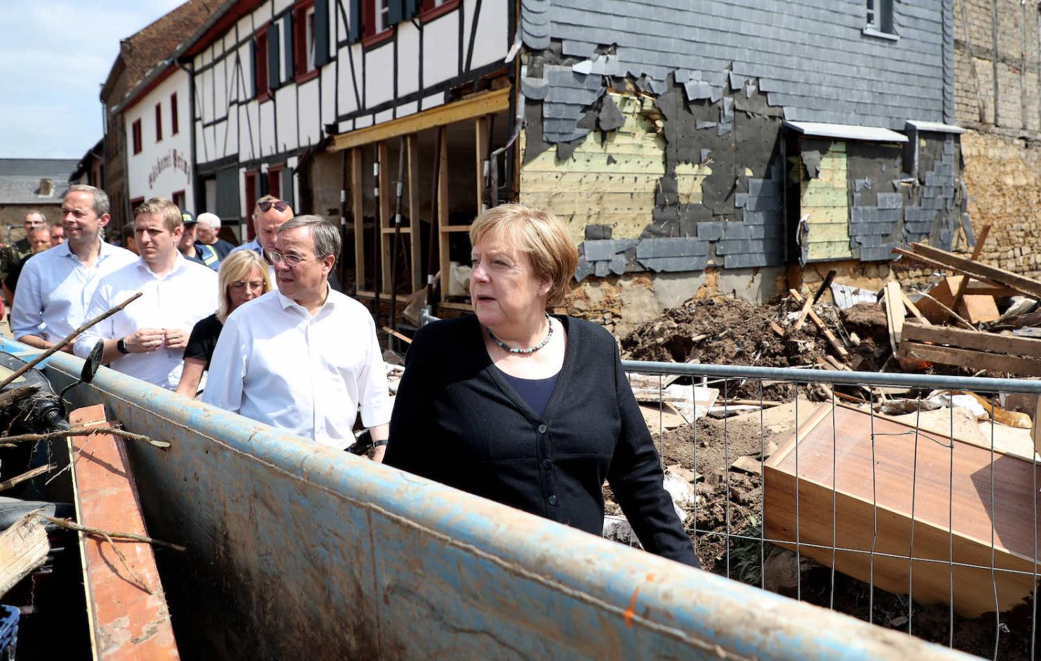 German Chancellor Angela Merkel inspecting damage after heavy flooding in the village of Bad Muenstereifel on 20 July. Merkel was accompanied by Armin Laschet, seen as a favourite to take over the chancellor position (Friedemann Vogel via Getty Images)