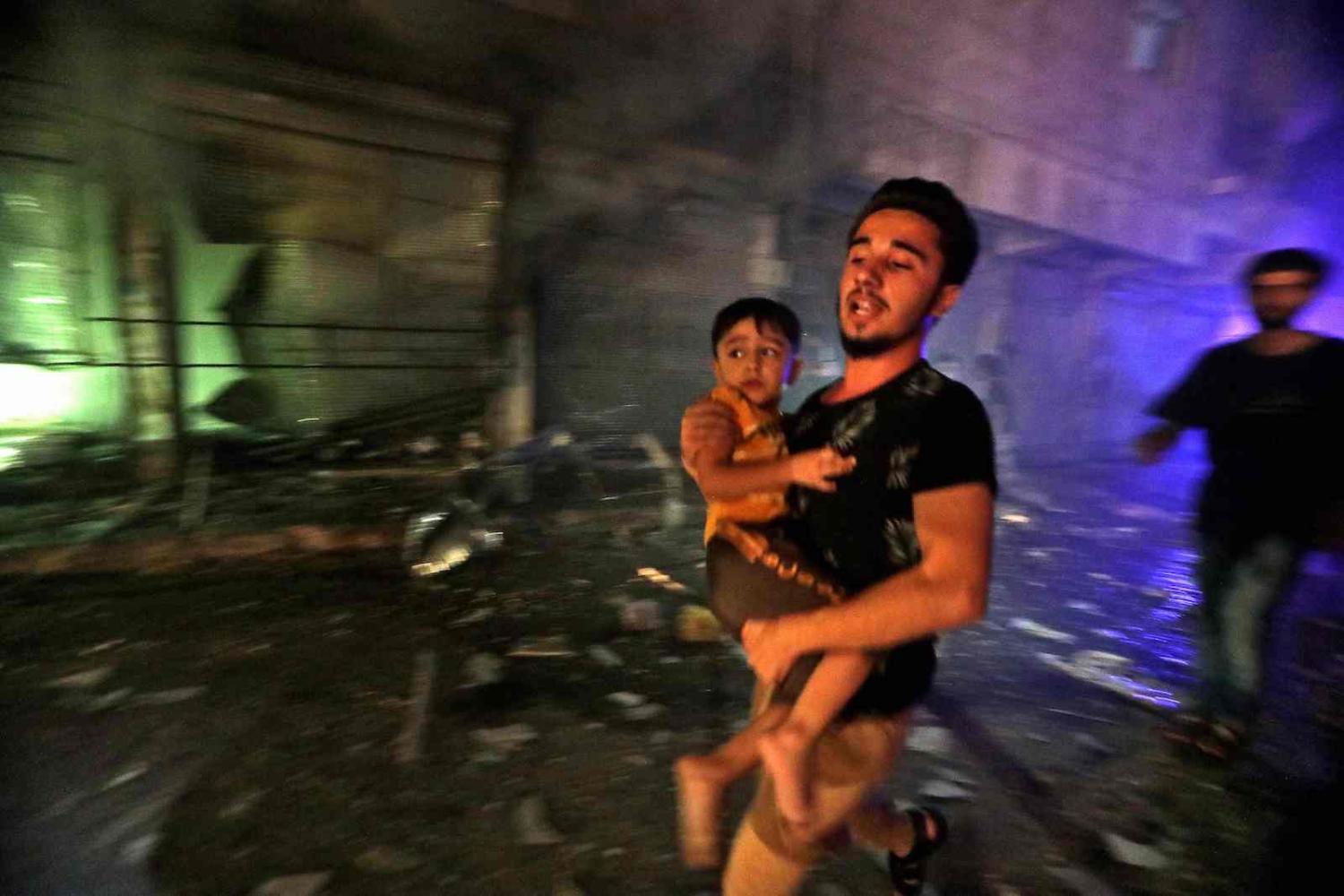 Fleeing a bombardment in the rebel-held city of al-Bab, northwest of Aleppo, northern Syria, on 6 August (Bakr Alkasem/AFP via Getty Images)
