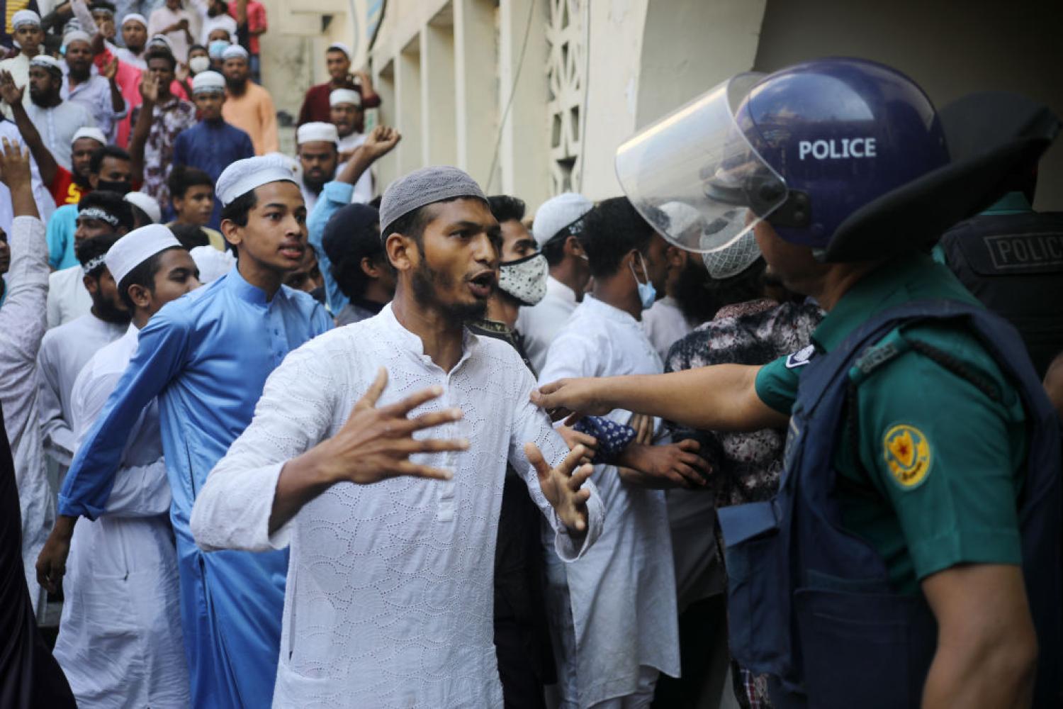 Police try to calm protesters during a demonstration after Friday prayers in Dhaka, Bangladesh on 15 October (Syed Mahamudur Rahman/NurPhoto via Getty Images)