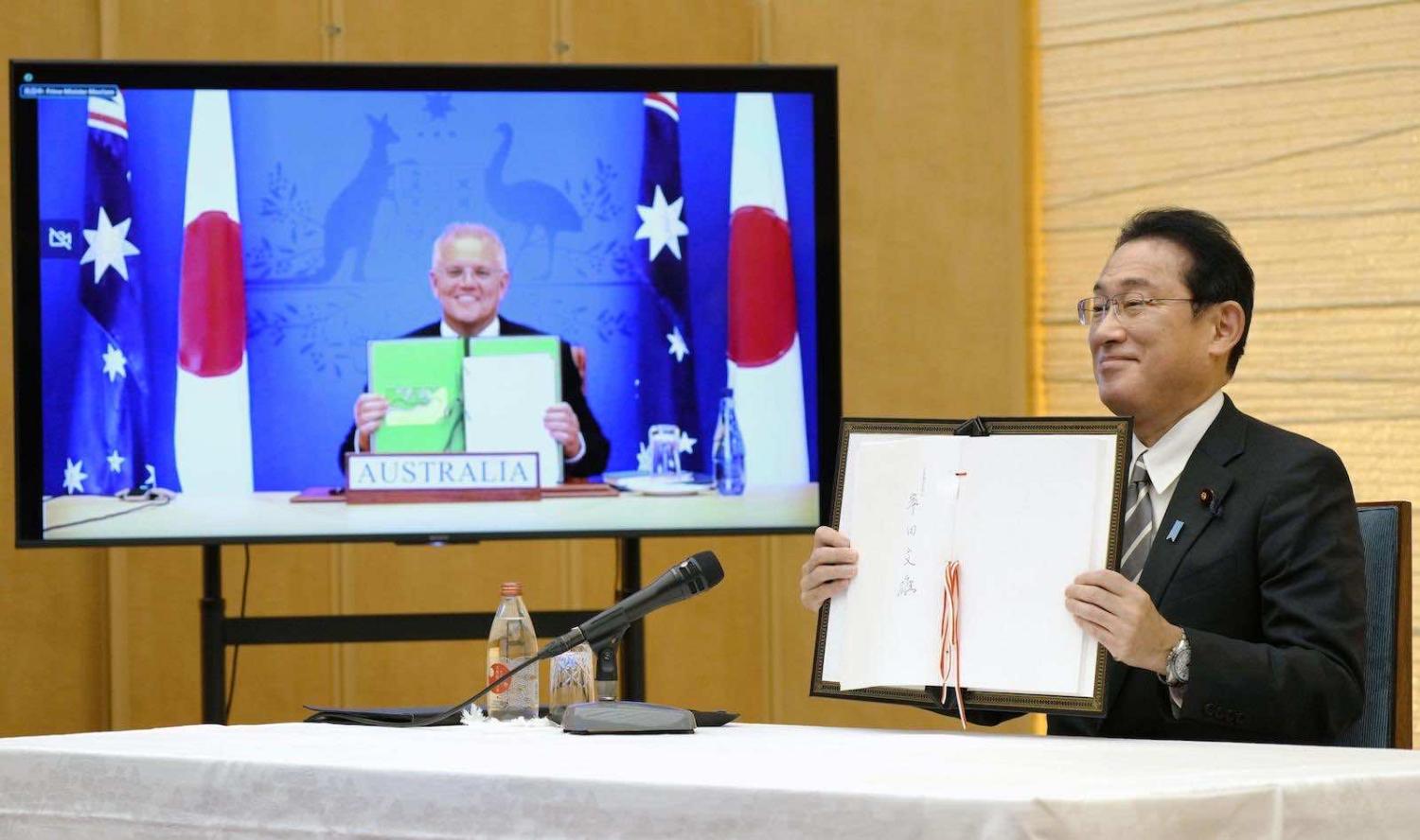 Japan’s Prime Minister Fumio Kishida iafter signing a treaty to facilitate joint exercises between Japan and Australia in a virtual meeting Prime Minister Scott Morrison (Kyodo News via Getty Images)