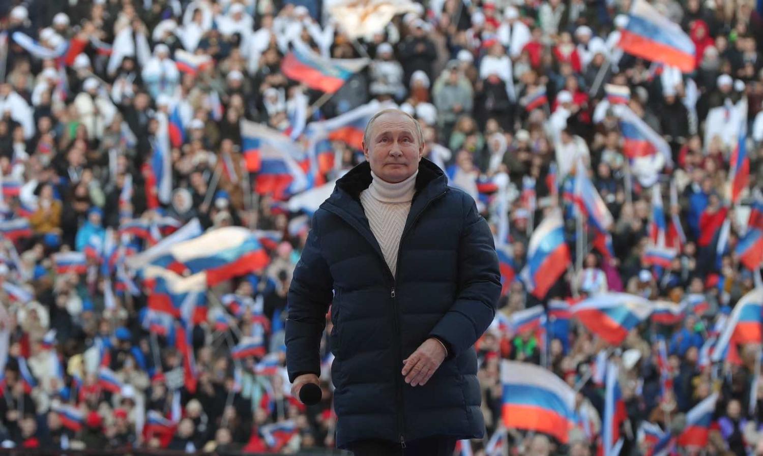 Russian President Vladimir Putin on 18 March during a concert at the Luzhniki stadium in Moscow marking eight years after Russia’s annexation of Crimea (Photo by Mikhail Klimentyev/Sputnik/AFP via Getty Images)