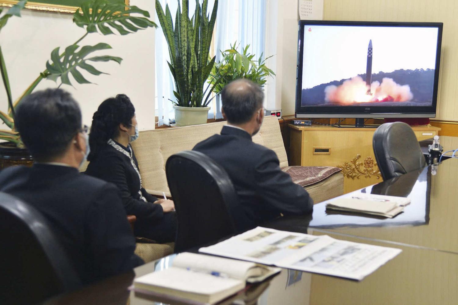 People watch Korean Central Television’s news of the previous day’s launch by North Korea of a new “Hwasong-17” intercontinental ballistic missile in Pyongyang on 25 March 2022 (Kyodo News via Getty Images)