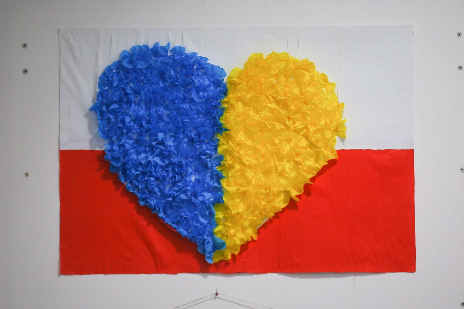 A decoration using the colours of the Ukrainian and Polish flags seen on the wall in a refugee shelter in Warsaw (Aziz Karimov via Getty Images)