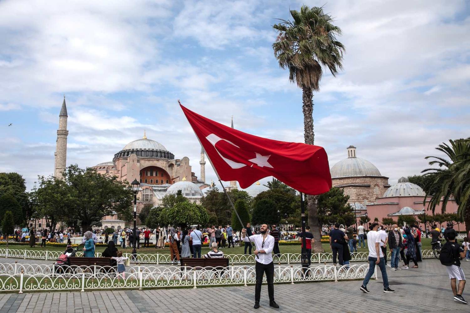 A man waves Turkey's flag near the Hagia Sophia Mosque on the fourth anniversary of the 2016 failed coup attempt, Istanbul, 15 July 2020 (Chris McGrath/Getty Images)