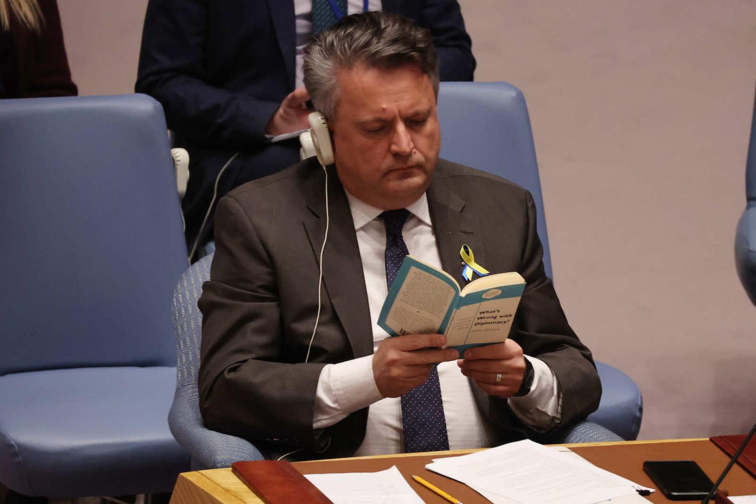 Ukraine ambassador Sergiy Kyslytsya reads the book “What's Wrong With Diplomacy?” by Kerry Brown as Russia’s ambassador speaks at the UN Security Council on 29 March (Spencer Platt/Getty Images)