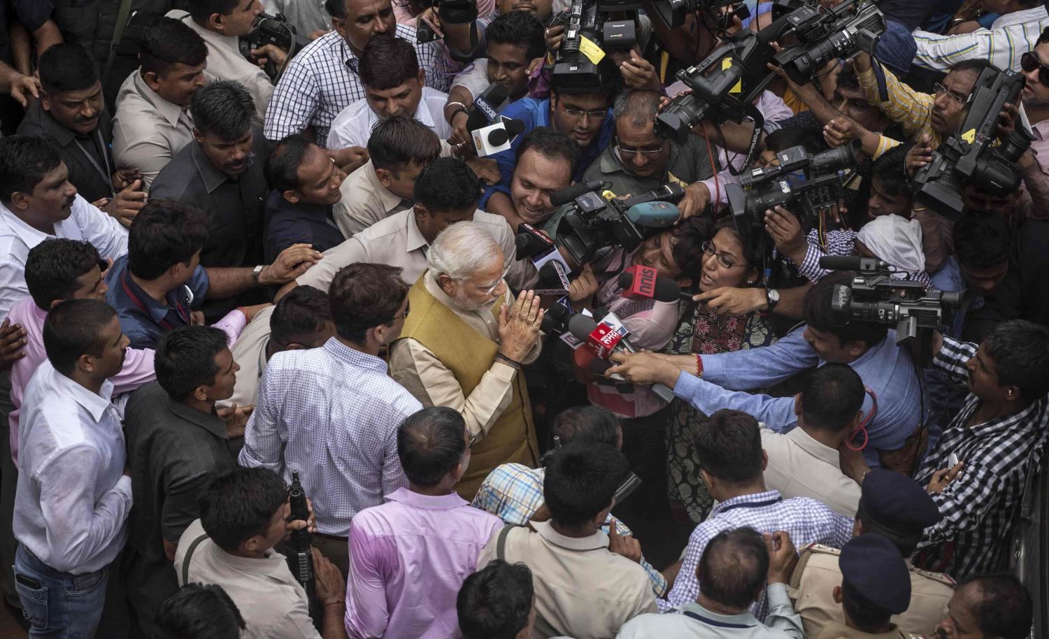 India's Narendra Modi mobbed in a press pack (Photo: Kevin Frayer/Getty)