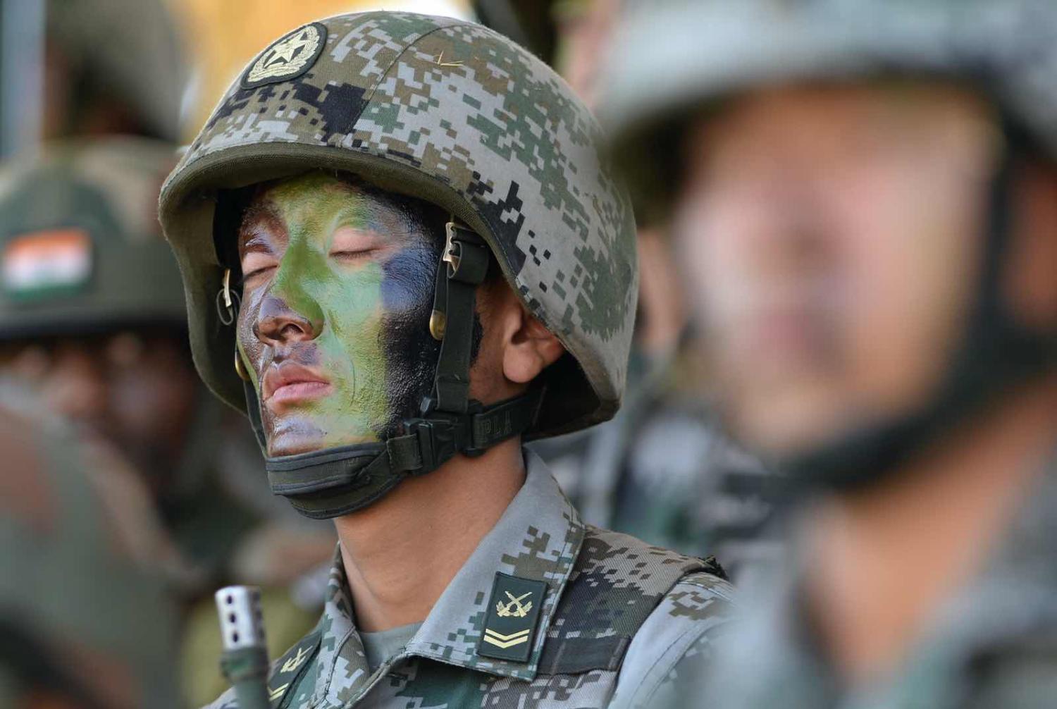 The PLA has come a long way from its humble origins as a foot-soldier heavy military, but recruiting and retaining talented personnel, and educating them in modern warfare doctrine remain among its challenges (Indranil Mukherjee/AFP via Getty Images)