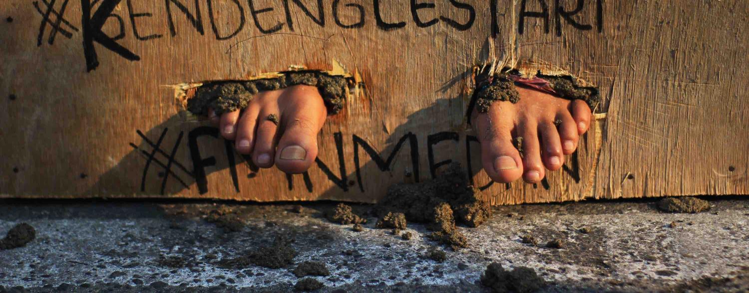 Protesters feet cemented in March 2017 in support for Kendeng farmers in Medan, Indonesia (Photo: Lana Priatna via Getty Images)