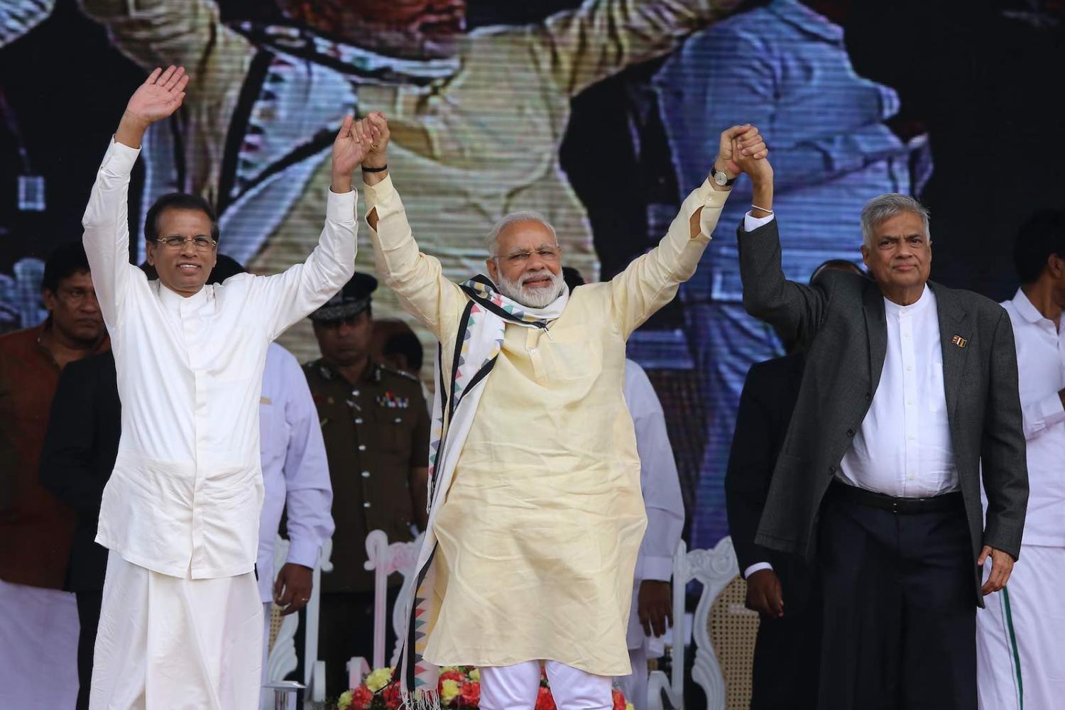 Indian Prime Minister Narendra Modi (centre) with Sri Lankan President Maithripala Sirisena (L) and Sri Lankan Prime Minister Ranil Wickremesinghe during a rally in Norwood, Sri Lanka, May 2017 (Photo: Tharaka Basnayaka via Getty)