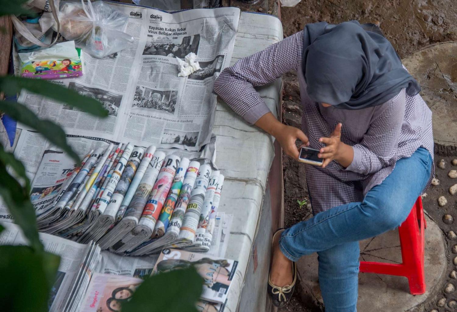 A newspaper vendor in Jakarta, Indonesia (Bay Ismoyo/AFP via Getty Images)