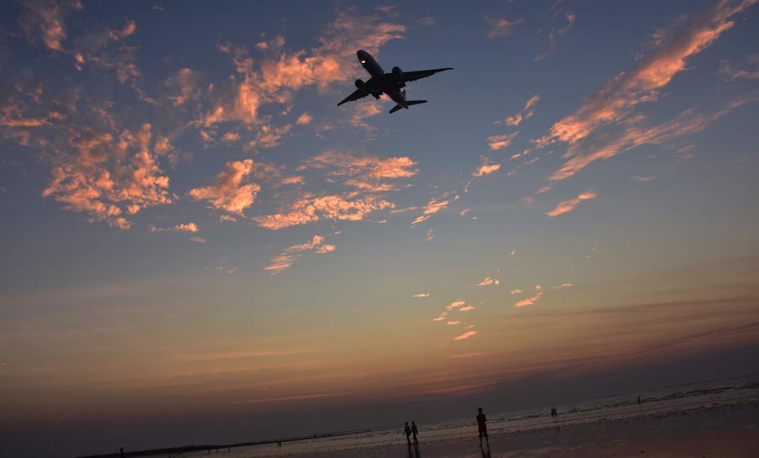 A plane flying over Juhu Beach in Mumbai, India (Photo: Azhar Khan via Getty)