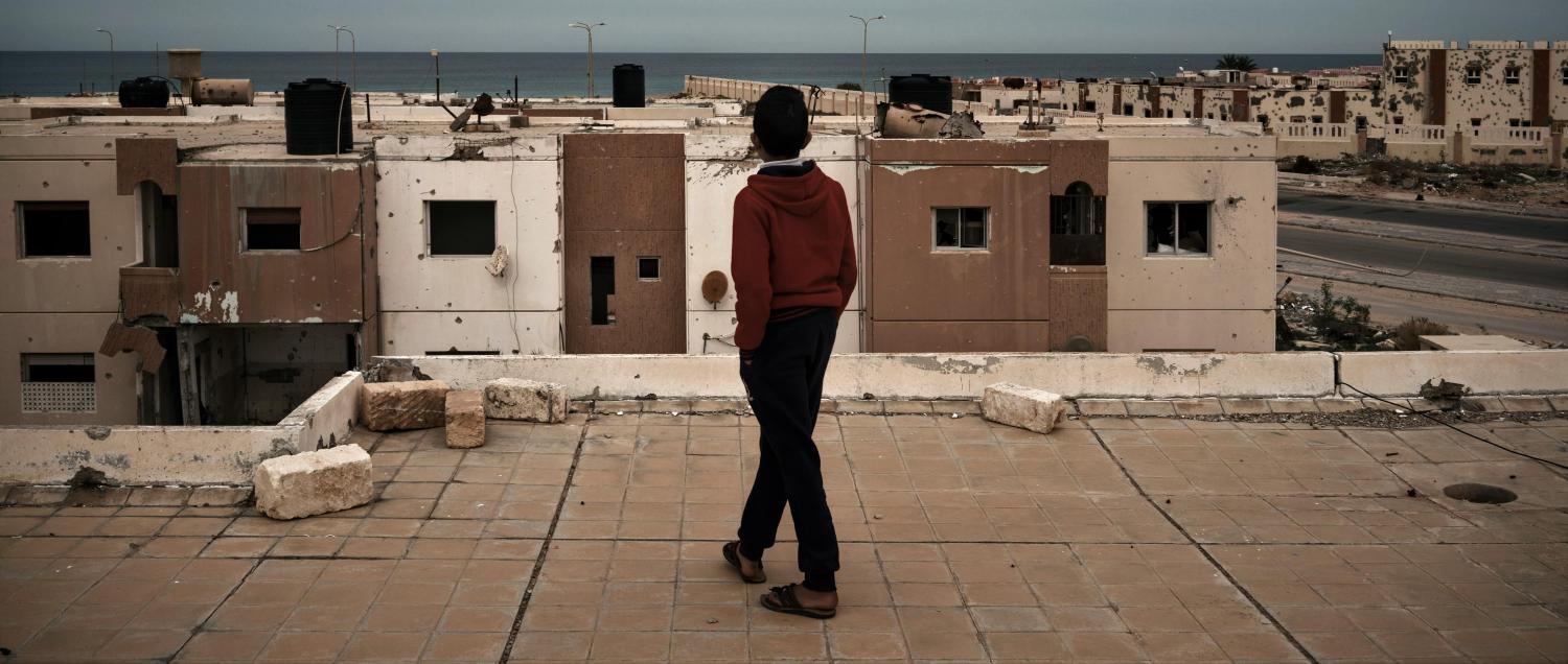 A boy walks along a building's roof in Sirte, Libya, December 2017 (Photo: Washington Post/Getty Images)