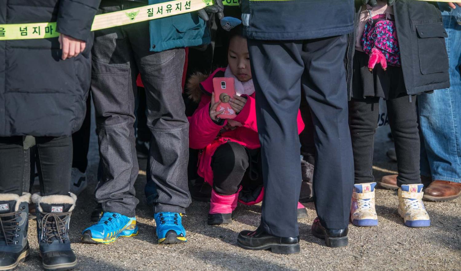 A girl crouches for a photograph during South Korea’s PyeongChang Winter Olympics in February (Photo: Carl Court/Getty) 